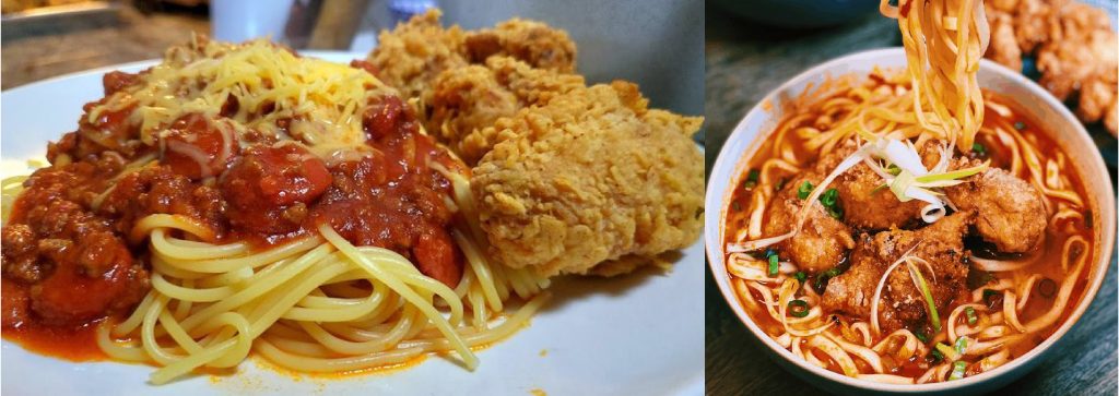 Crispy fried chicken served with a bed of flavorful noodles, garnished with vegetables and herbs.